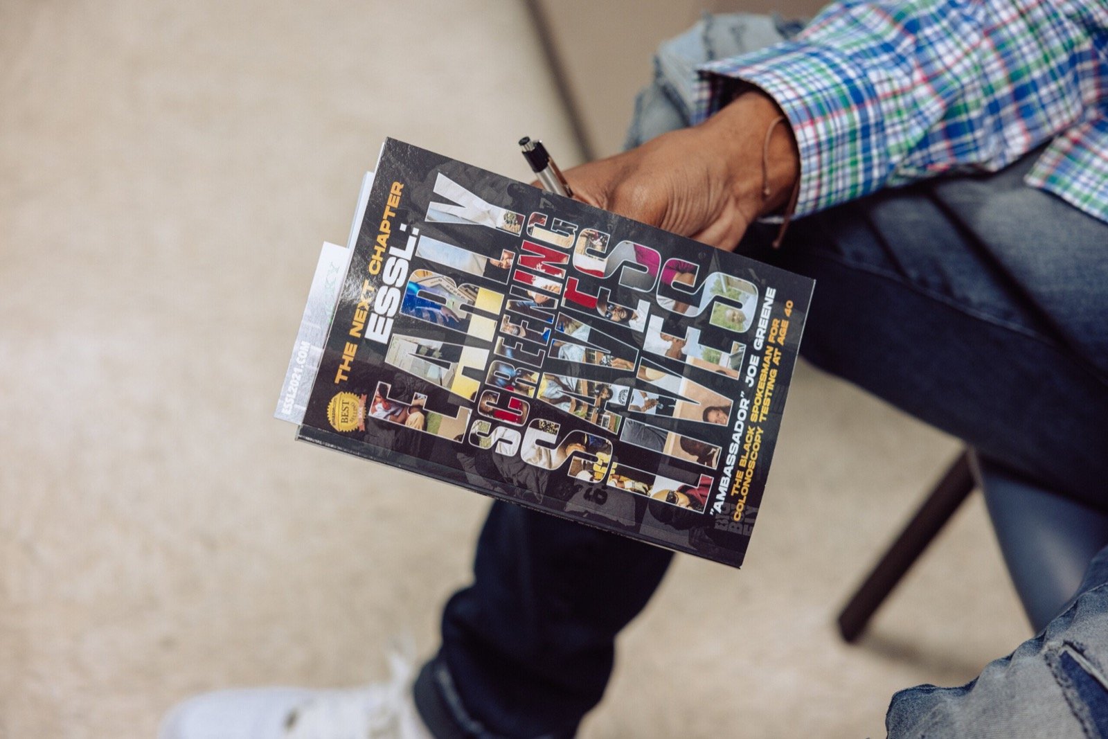 Joe Greene holding his book, The Next Chapter: ESSL